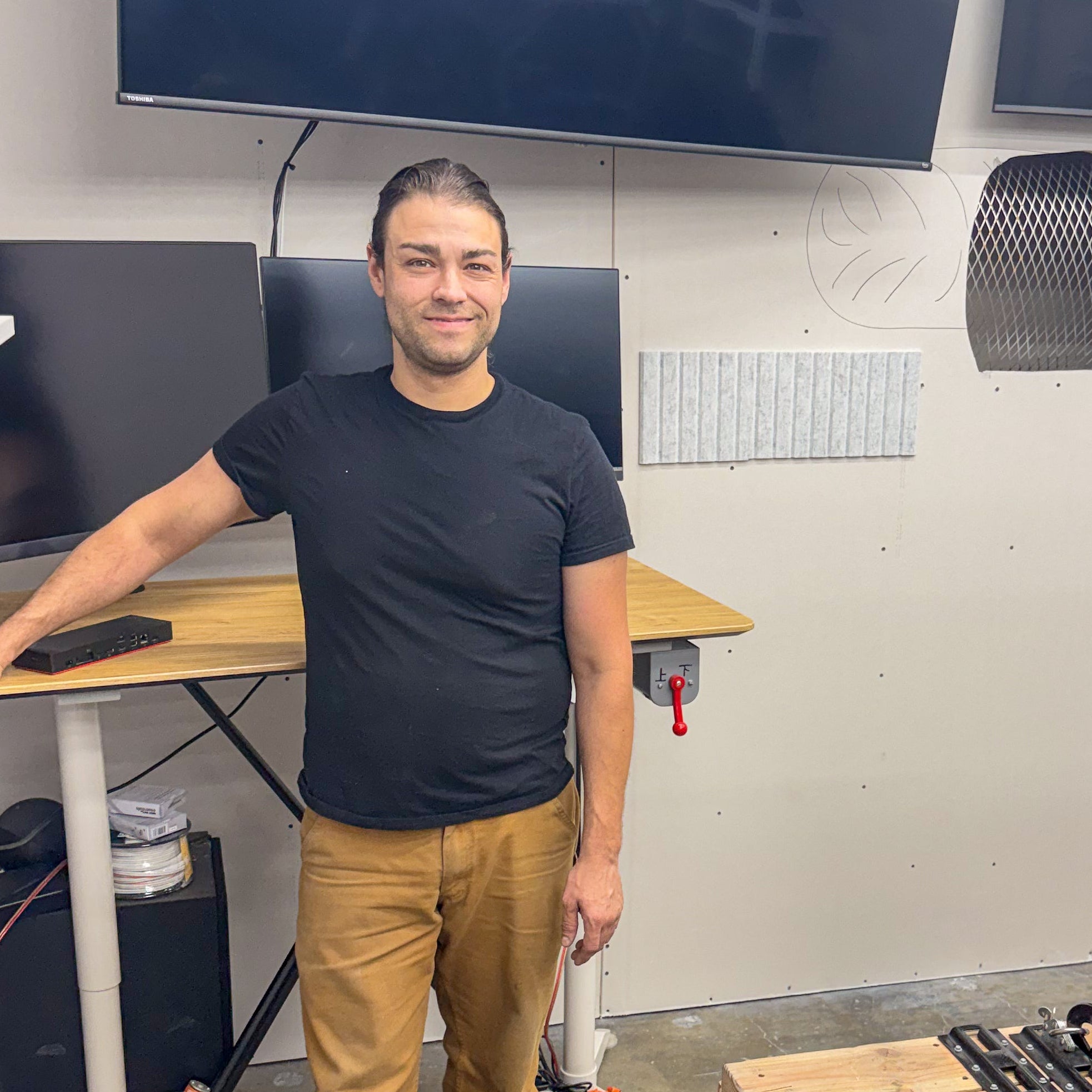 Chief Engineer Niko Hays stands in the dyno lab he built.